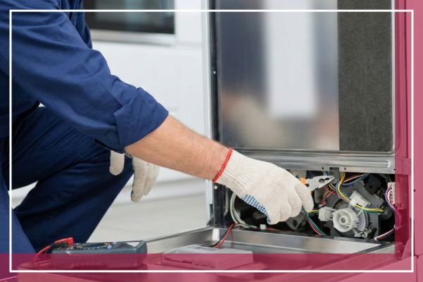 Close-up of a technician's gloved hands using pliers and a multimeter to repair internal components of a dishwasher.