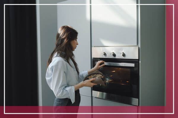 woman baking food in oven woman baking food in oven