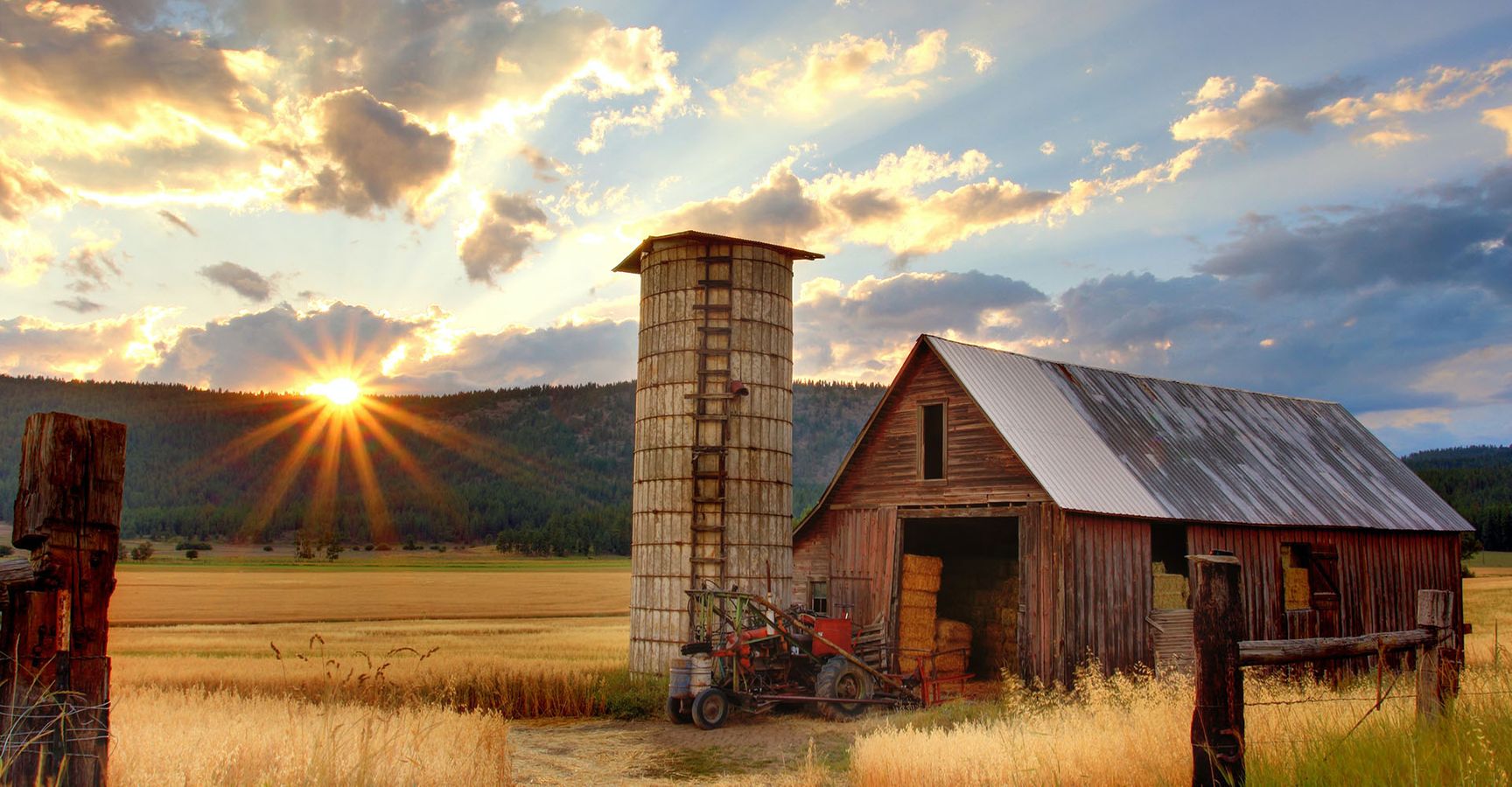 Barn with hay in it at sunset