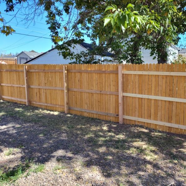 a long brown, wooden fence