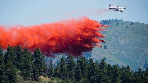 trail of wildfire red dust coming out airplane 