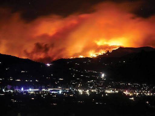 fire on the mountain range over the city 