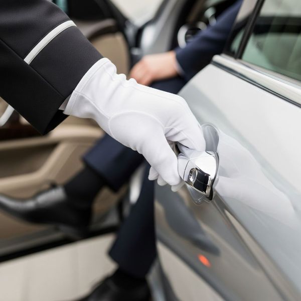 Chauffeur opening door with white glove Chauffeur opening door with white glove