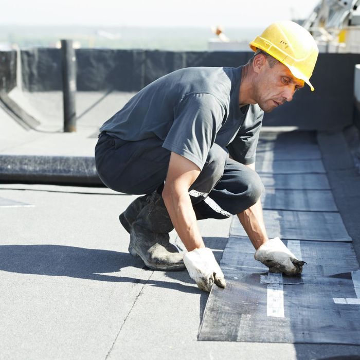 A man working on a building roof