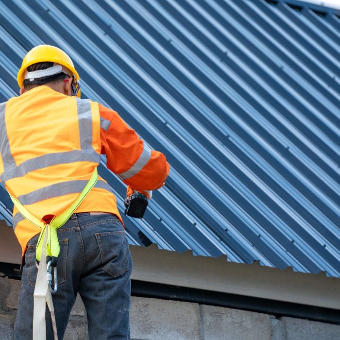 A worker working on a business' roof