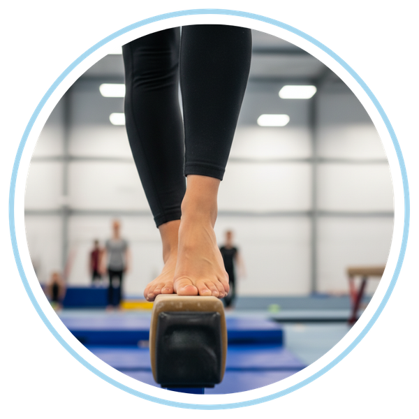 woman practicing gymnastics on a beam
