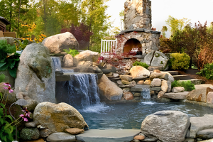 a water feature and an exterior fireplace