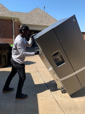 Man moving refrigerator