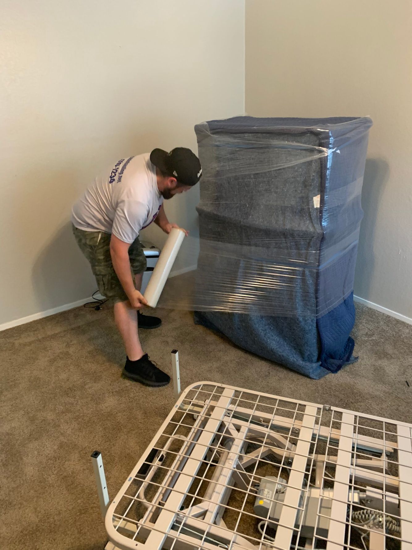 Man wrapping furniture to move safely
