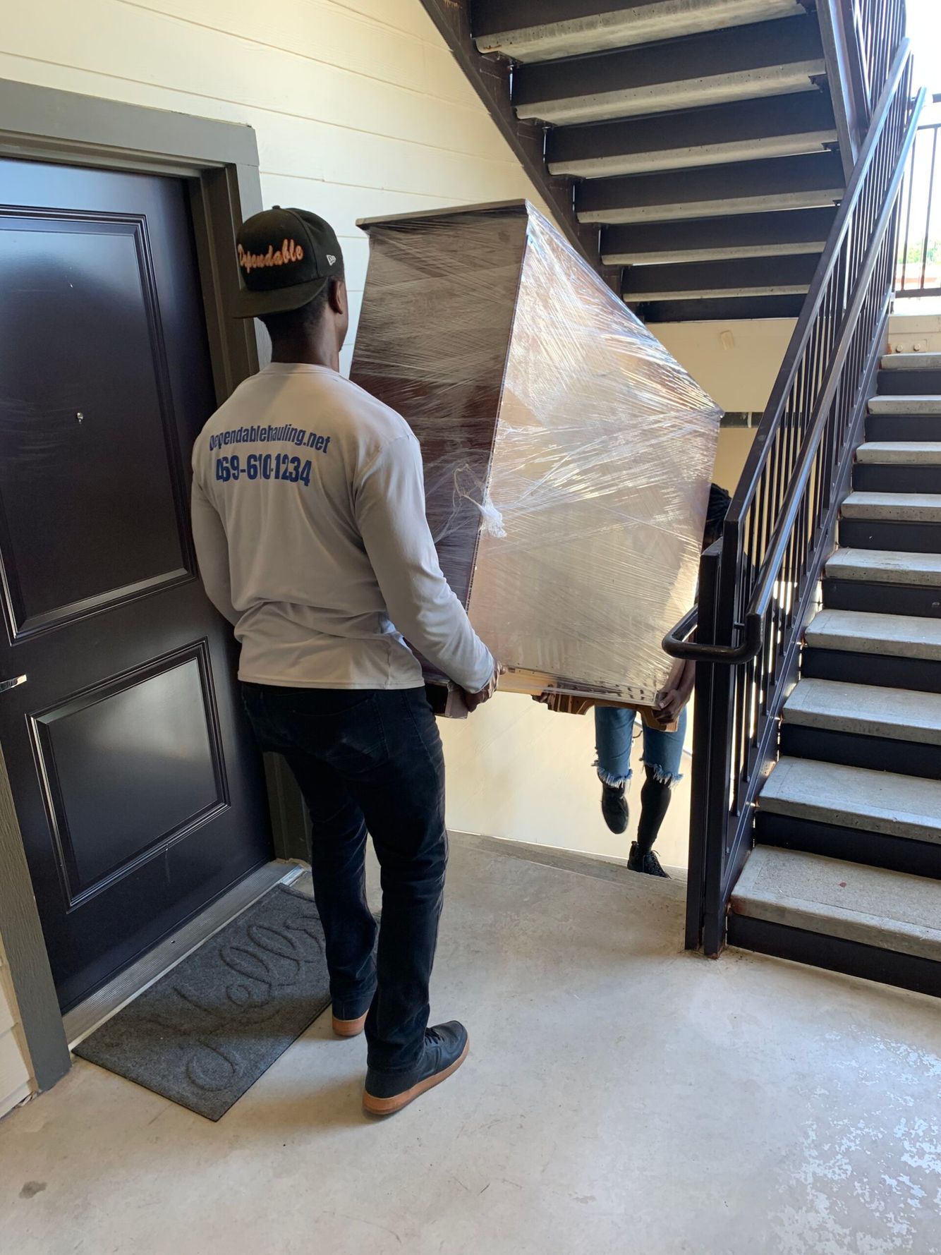 Men moving furniture down stairs