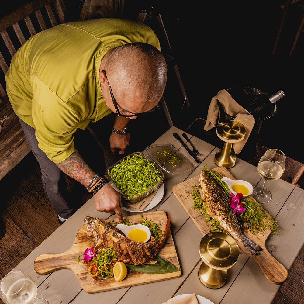 chef preparing two fish means with beautiful presentation