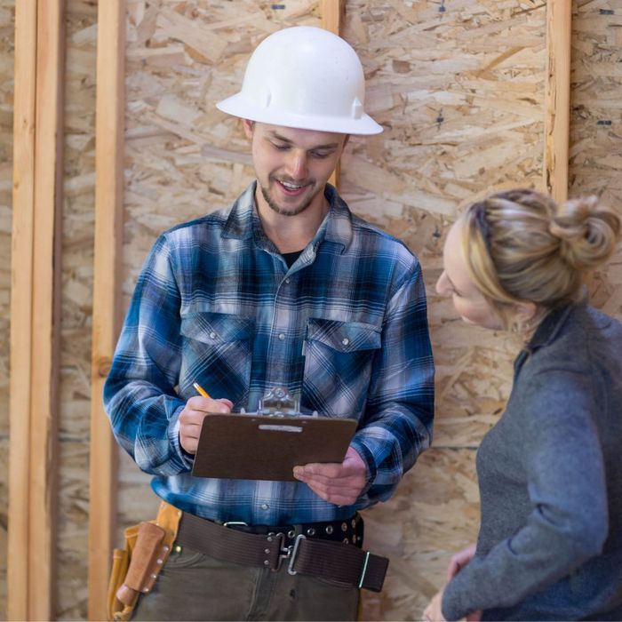 woman talking to a contractor with hard hat