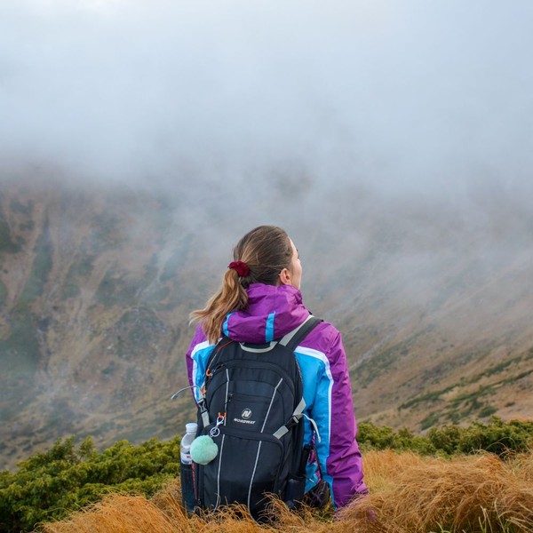 woman on a hike looking out from summit