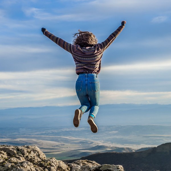 woman jumping while on a hike woman jumping while on a hike