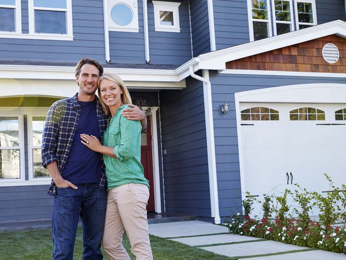 couple in front of house