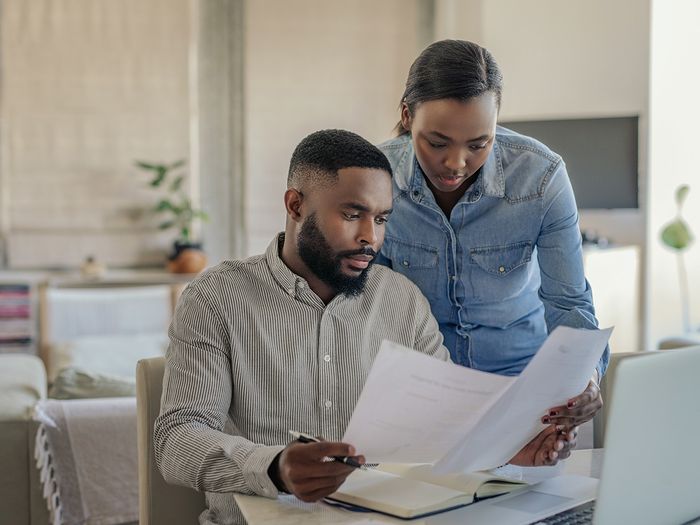 A couple looking over paperwork from a realtor