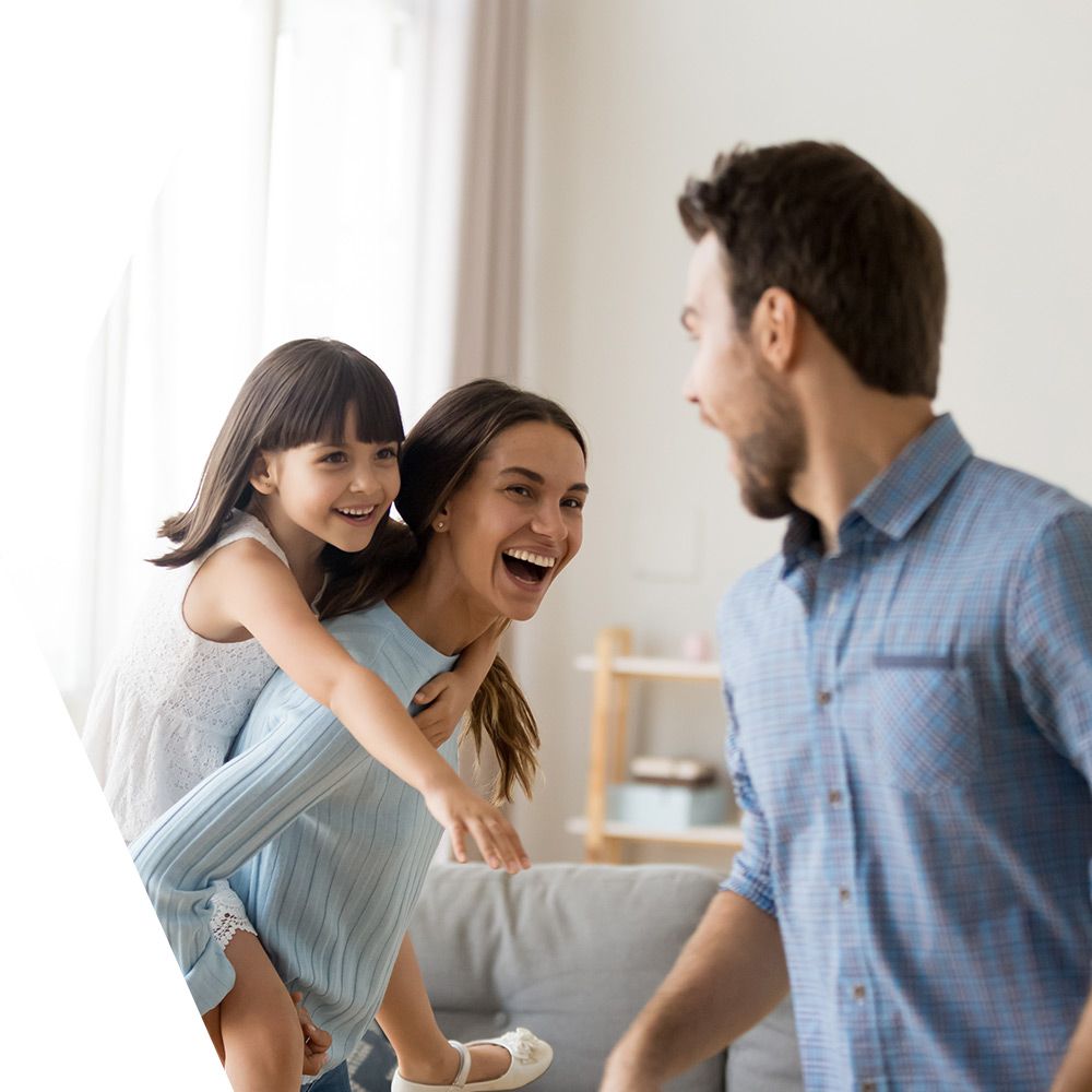 Family laughing in their living room