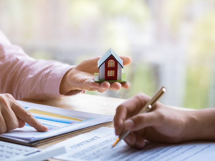 Two people looking at housing cost paperwork