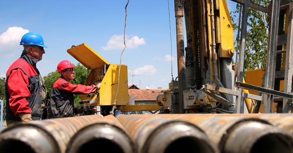 Construction workers preparing to drill