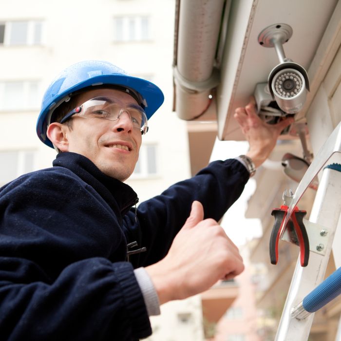 man installing security camera