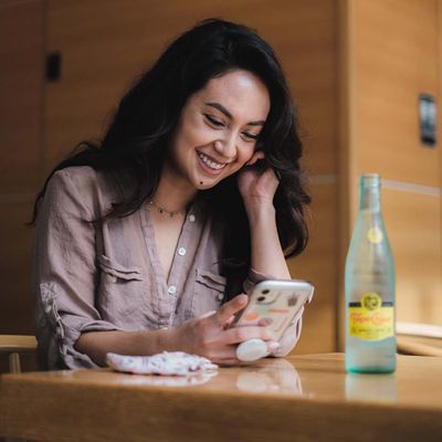 Woman booking an appointment on her phone