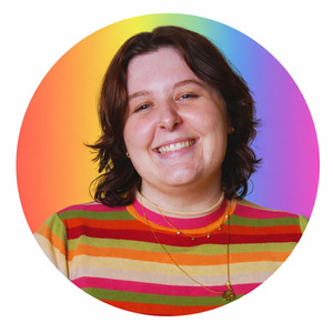Smiling portrait with rainbow background.png