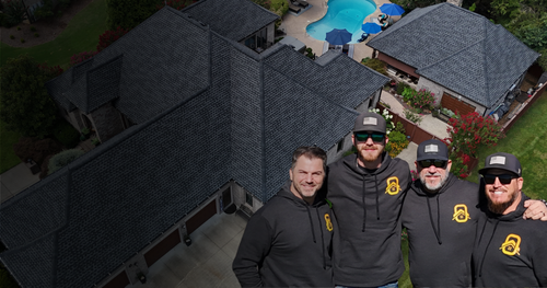 Onyx Roofing and Construction team in front of a completed Tennessee roof