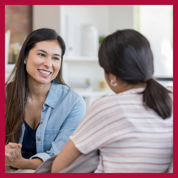 image of two people talking
