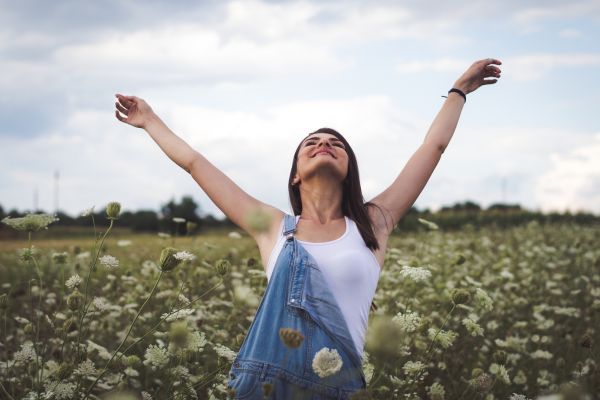 woman happy in a field of flowers
