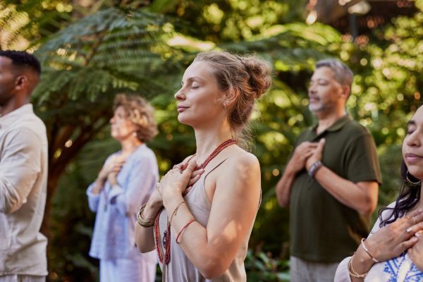 woman holding her heart in a meditation