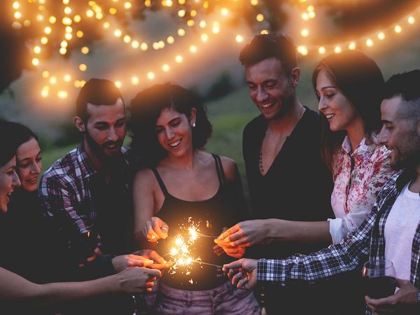 Group of people having a party and celebrating in a backyard. 