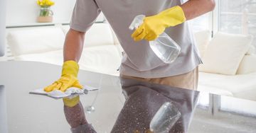 Image of man cleaning countertops in a home