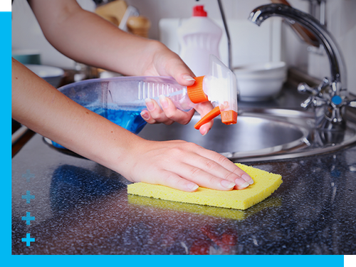 photo of woman cleaning kitchen counter tops