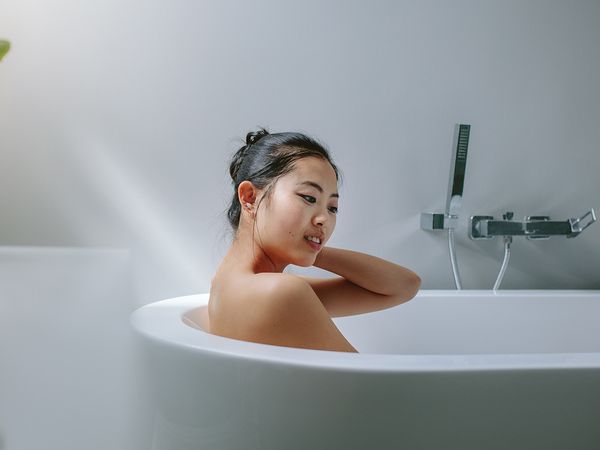 Woman relaxing in the bathtub.