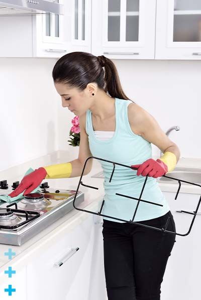 Woman cleaning stove top