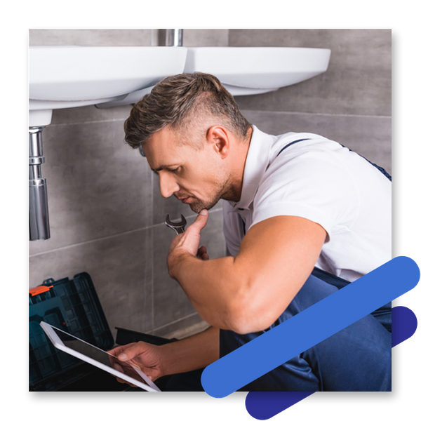 A plumber looking at a tablet
