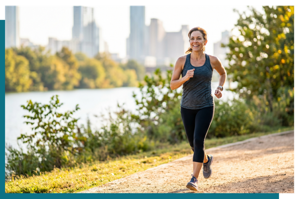a woman jogging energetically on a sunlit trail, symbolizing vitality after pituitary disorder treatment.