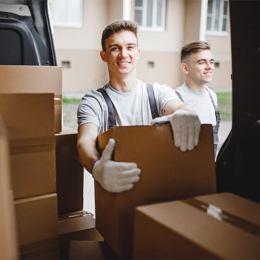 two happy delivery men with boxes