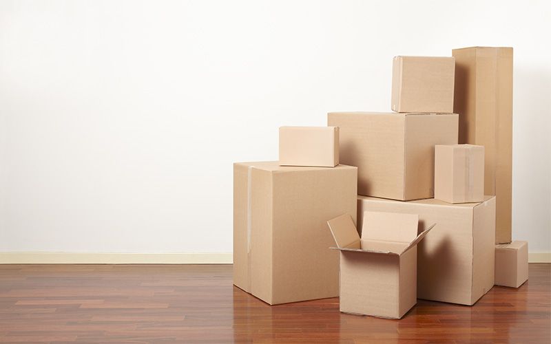 Pile of boxes on hardwood floor