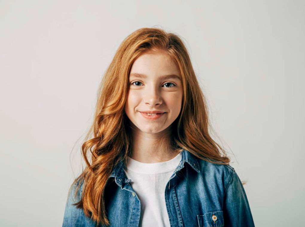 a young girl smiling at the camera