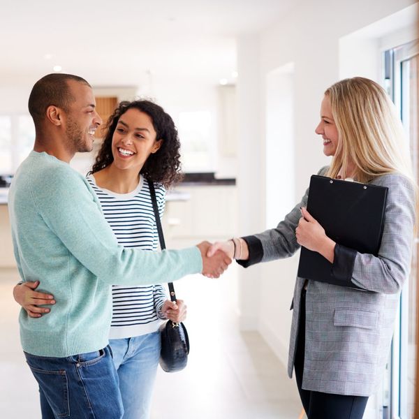 A realtor shaking hands with a client 