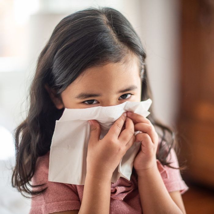 girl wiping her nose