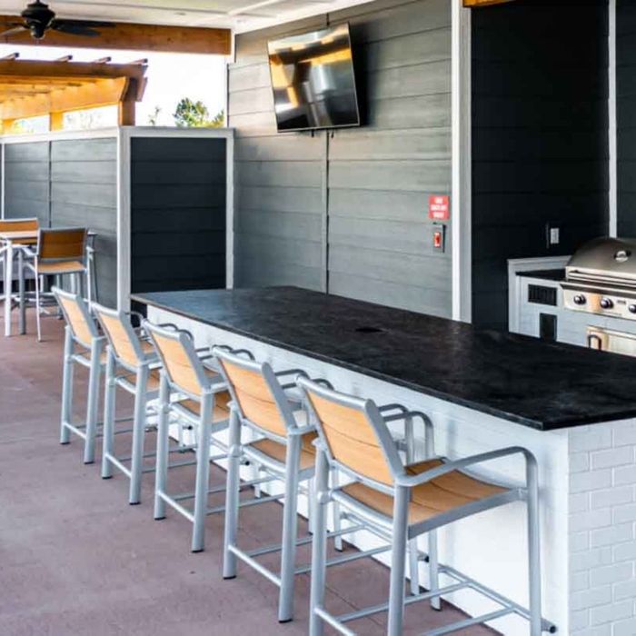 outdoor kitchen and island with seating for social gatherings