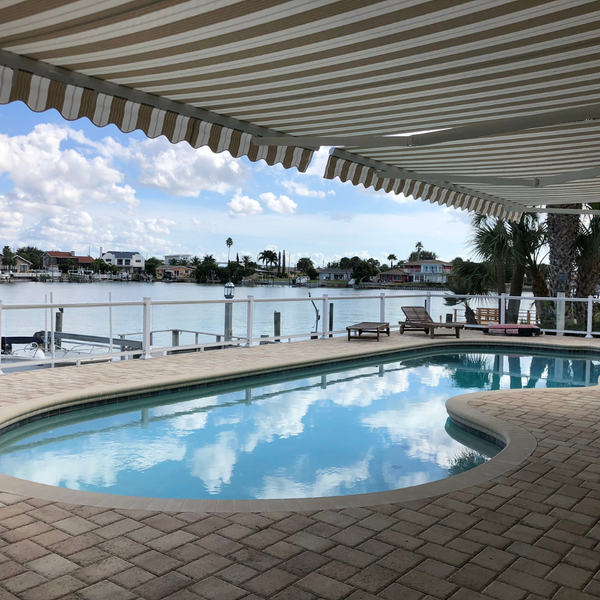 Retractable awning above a pool