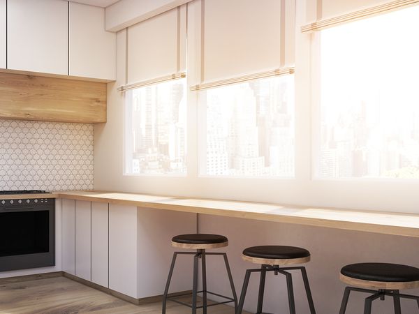 Home kitchen with shades over windows. 