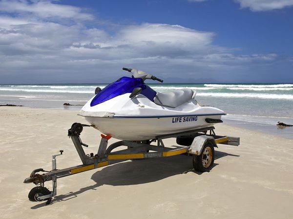 jet ski on a trailer sitting on beach