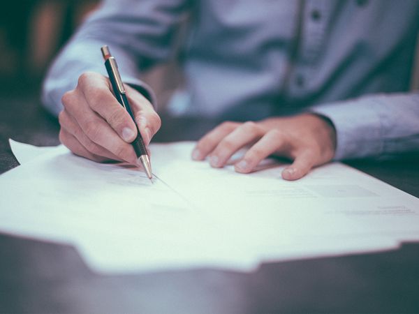 man signing jet ski insurance paperwork