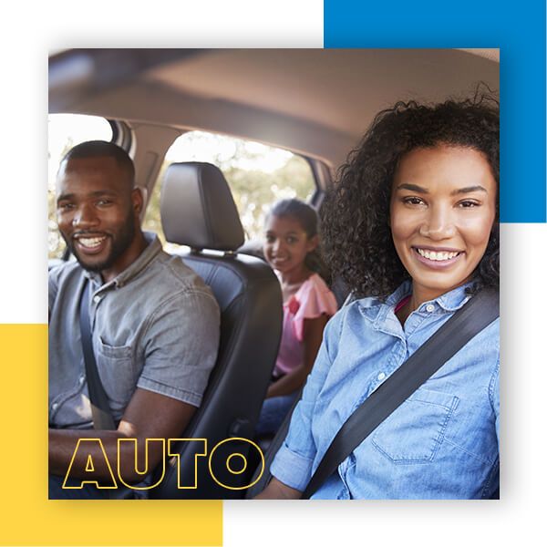 Family smiling from inside a car while wearing seatbelts