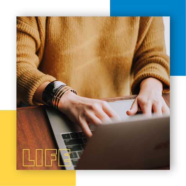 Woman in yellow sweater using computer