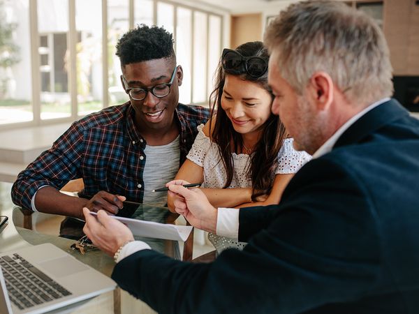 young couple signing up for condo insurance